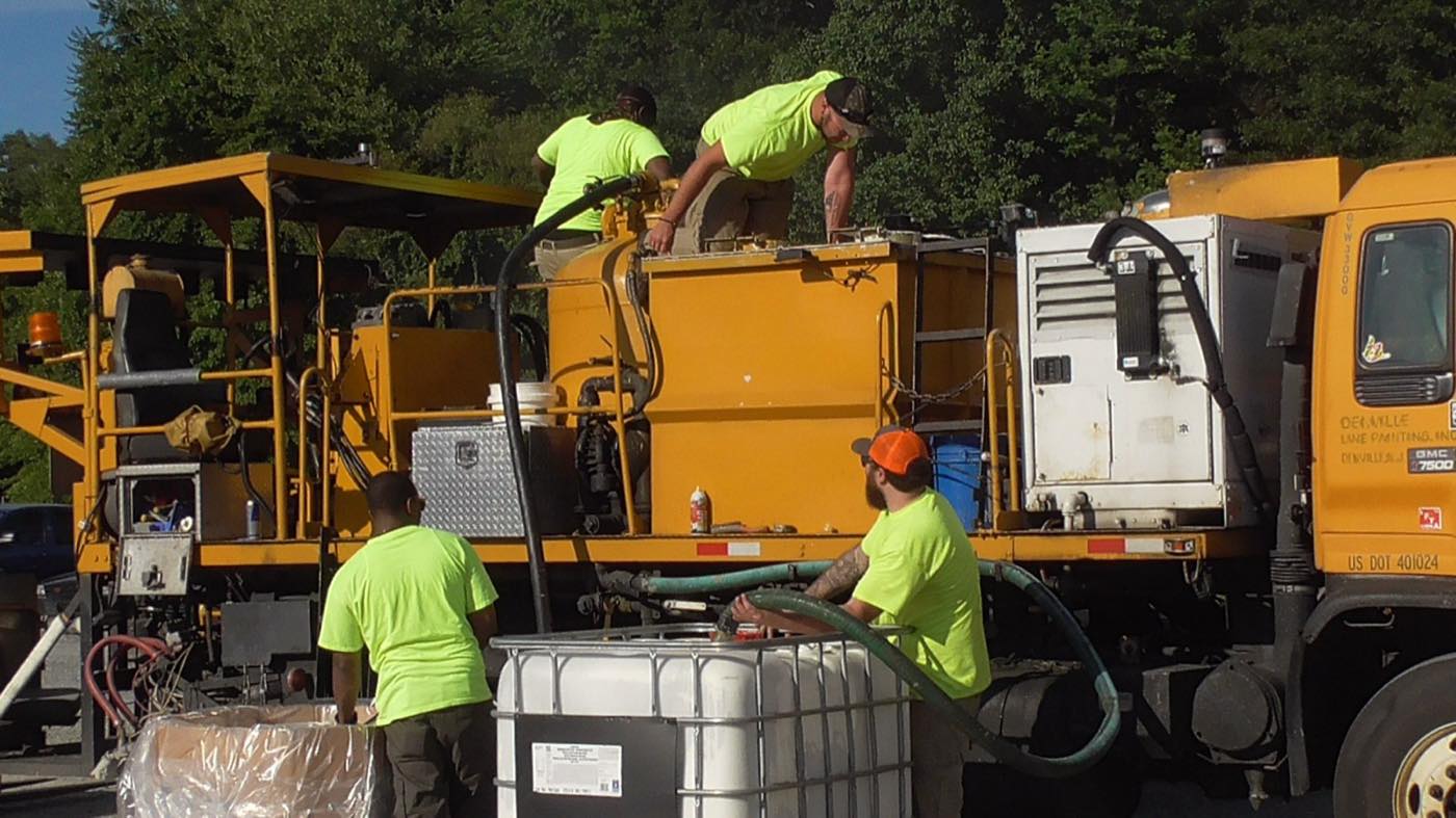 Denville Line Painting crew loading a striping truck